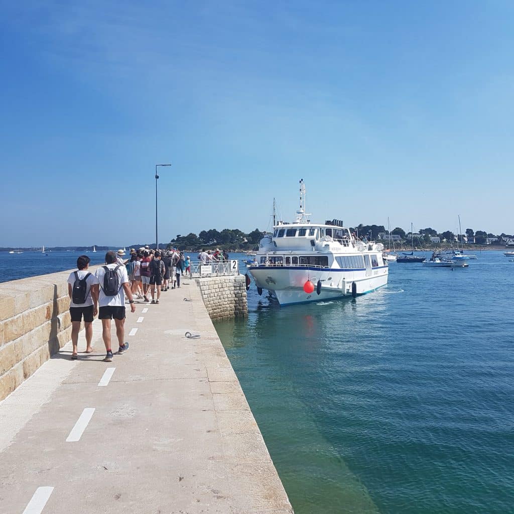 Bateau arrivant à un quai avec des passagers.